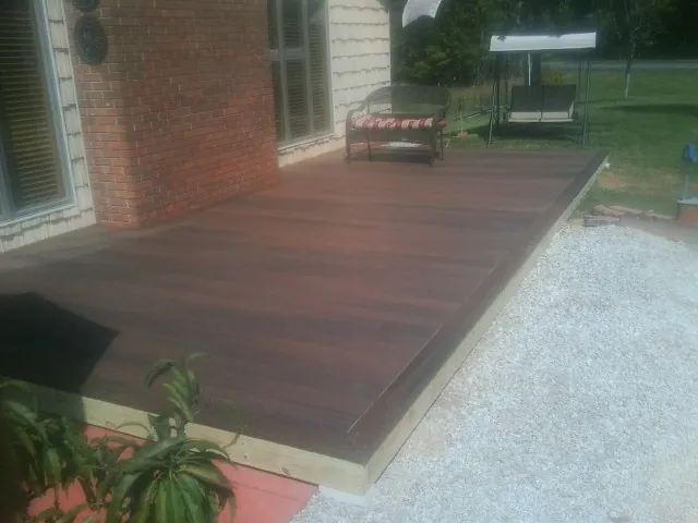 Freshly stained wood deck built against a brick home in Adamsburg